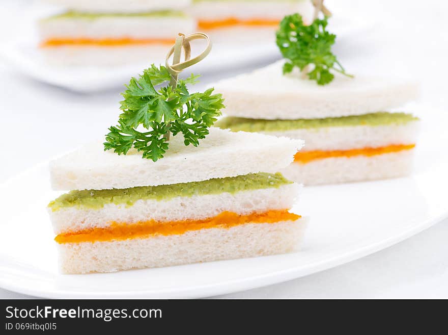 Vegetarian colorful sandwich with vegetable puree on the plate, close-up