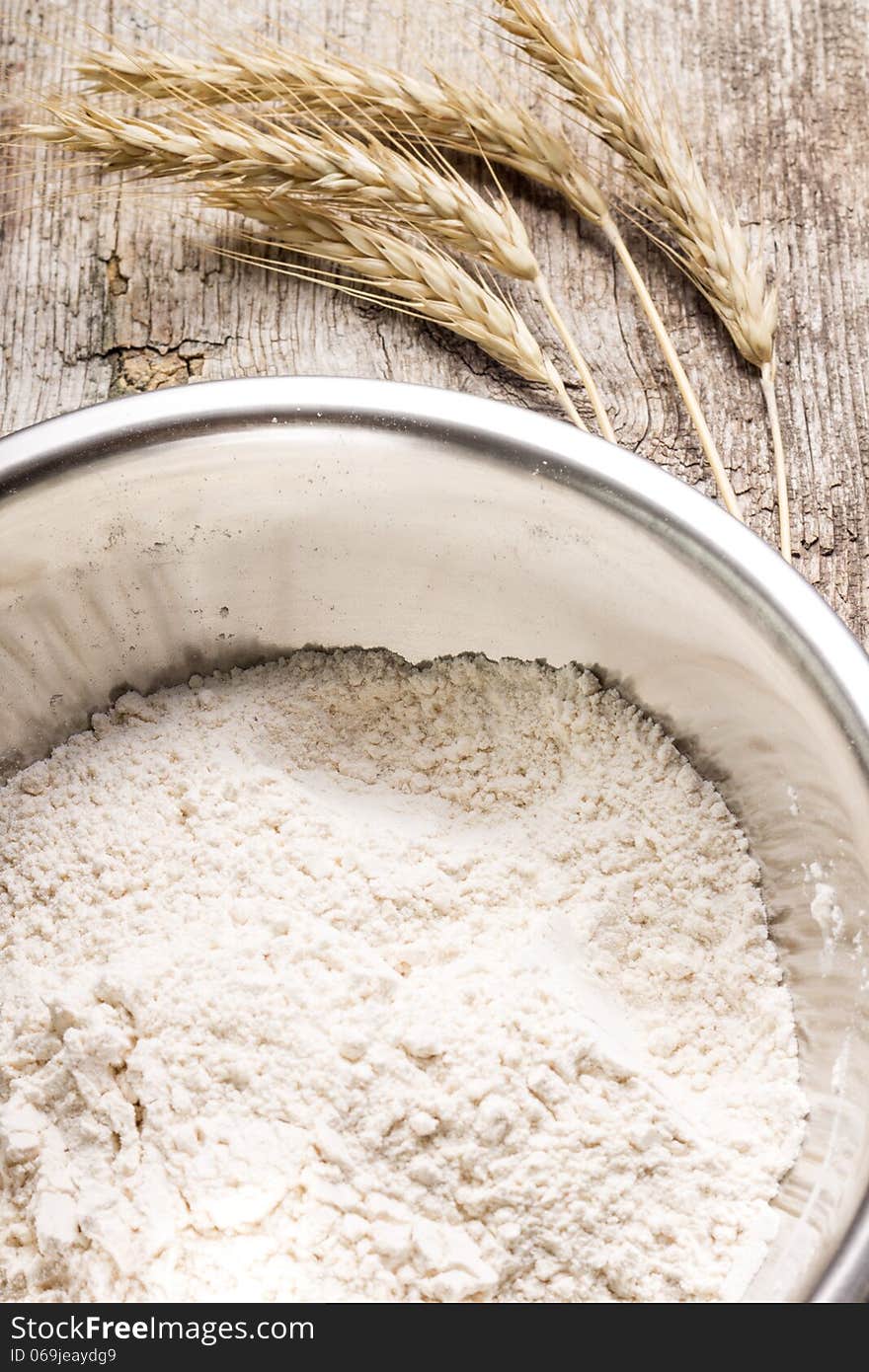 Mixing wheat flour in metallic bowl