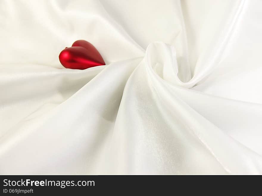 White smooth satin cloth with red heart