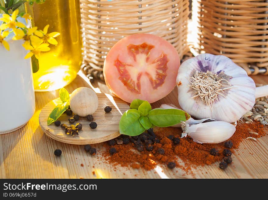 Fresh tomato garlic basil with red and black pepper on a table at a domestic kitchen. Fresh tomato garlic basil with red and black pepper on a table at a domestic kitchen