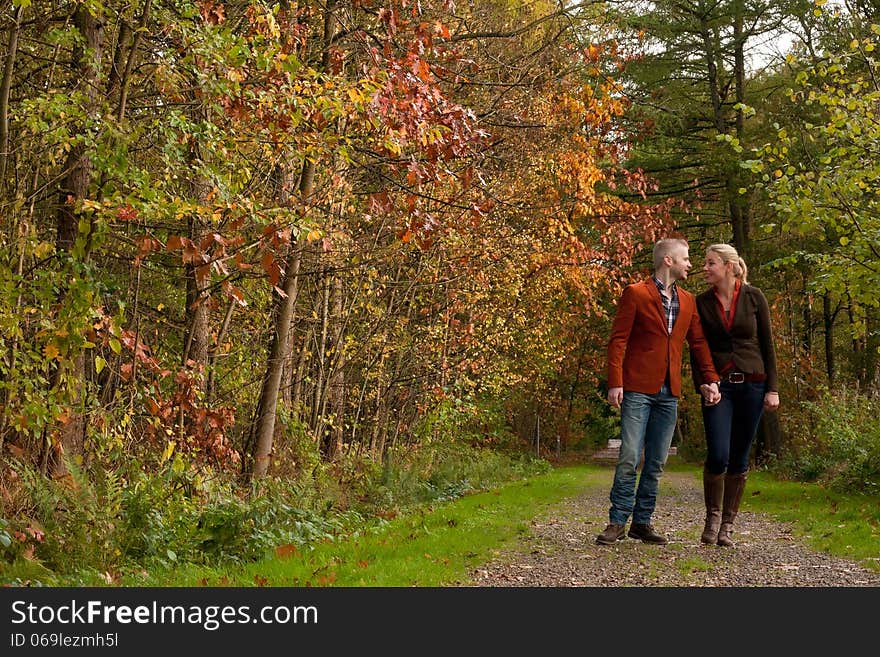 Happy couple is taking a walk in the forest