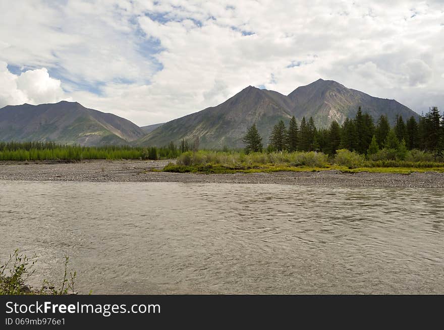 The Sky In The Clouds Over The Mountain River.