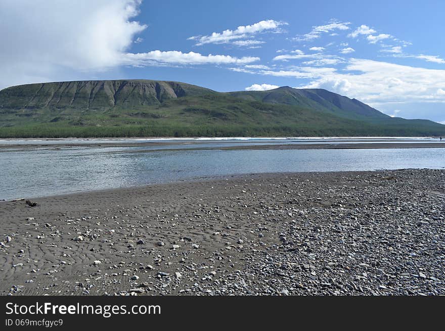 Pebble spits in the riverbed Suntar.