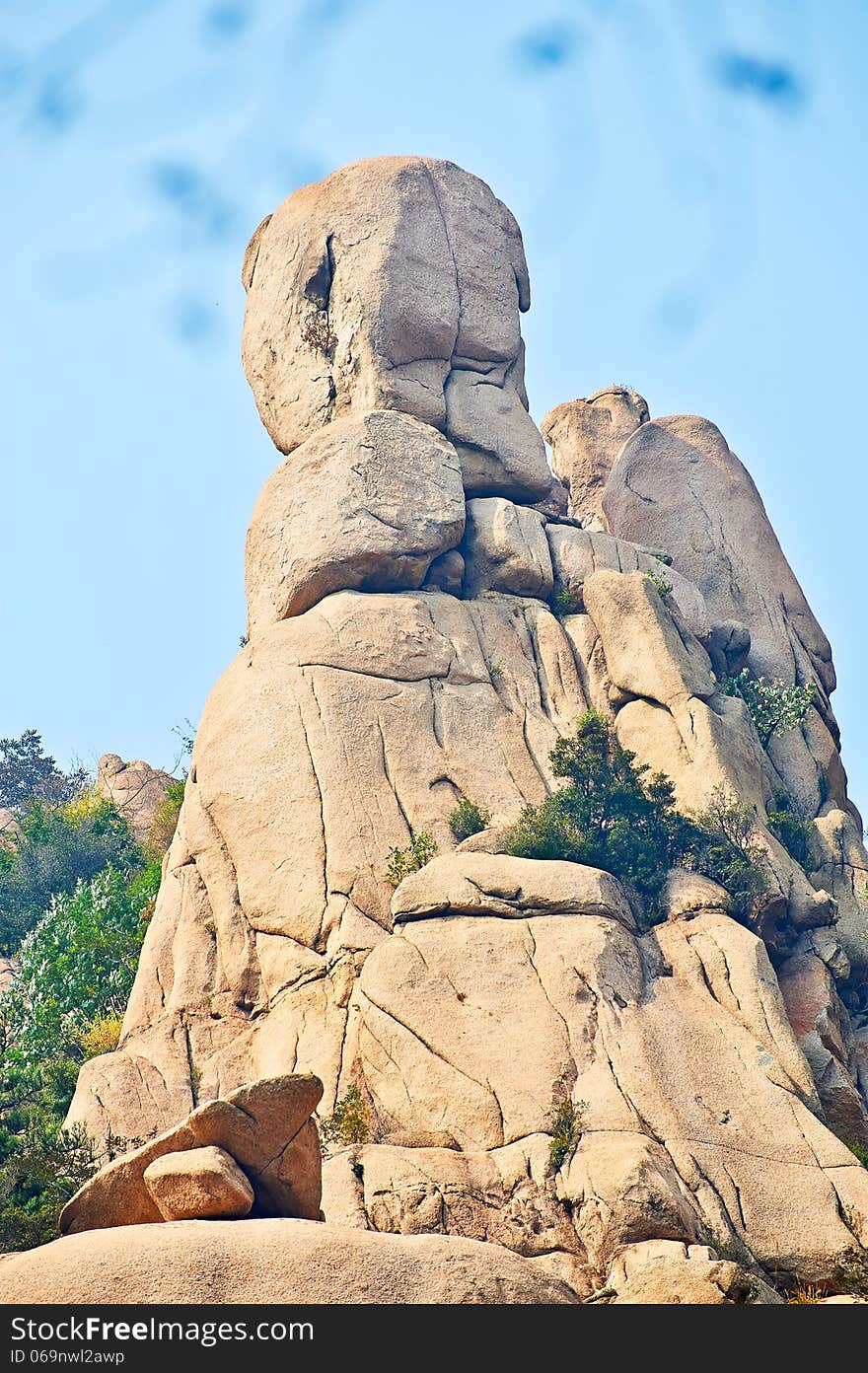 The stone man looking sea and autumnal scenery