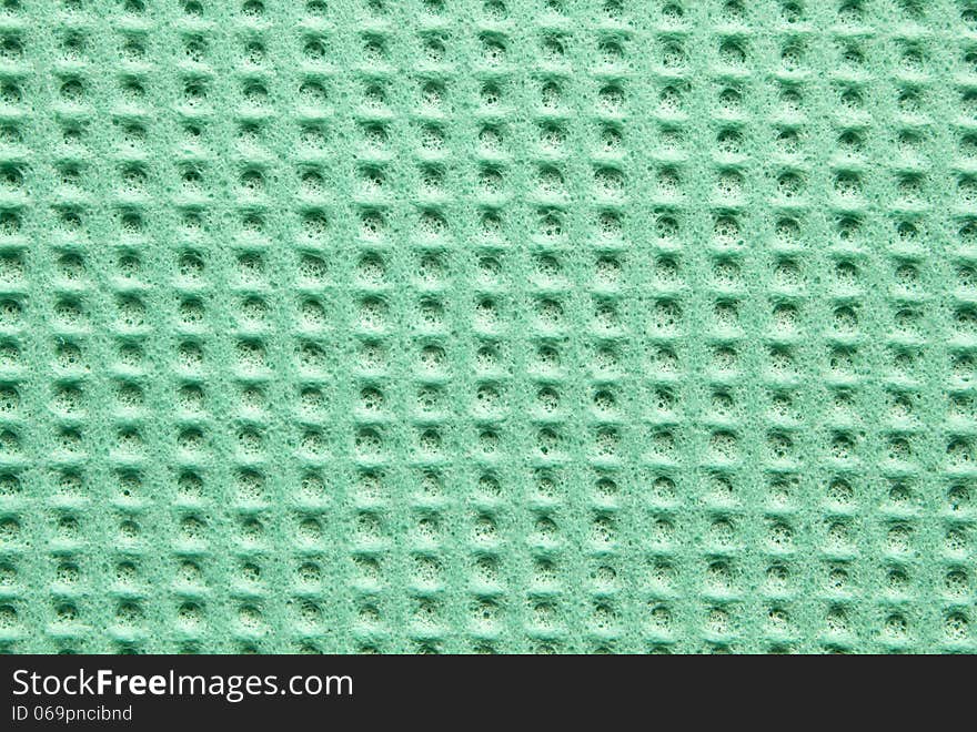 Green texture cellulose kitchen sponge as background. Green texture cellulose kitchen sponge as background