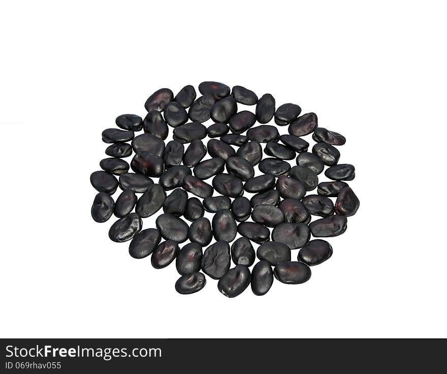 Black beans on a light background. Lie in the shape of a circle. Black beans on a light background. Lie in the shape of a circle