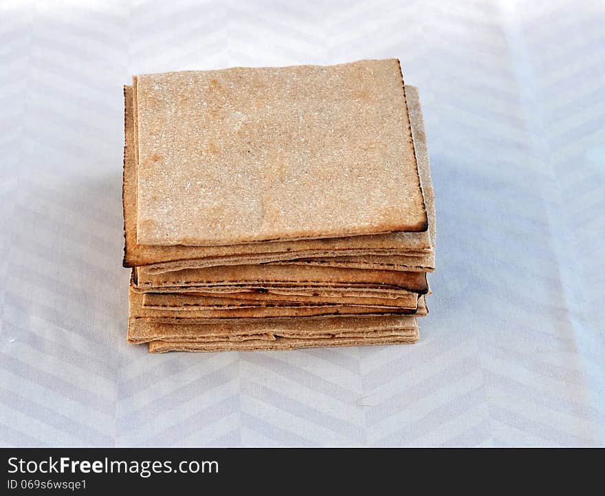 Pita bread cut in squares and stacked together. Pita bread cut in squares and stacked together