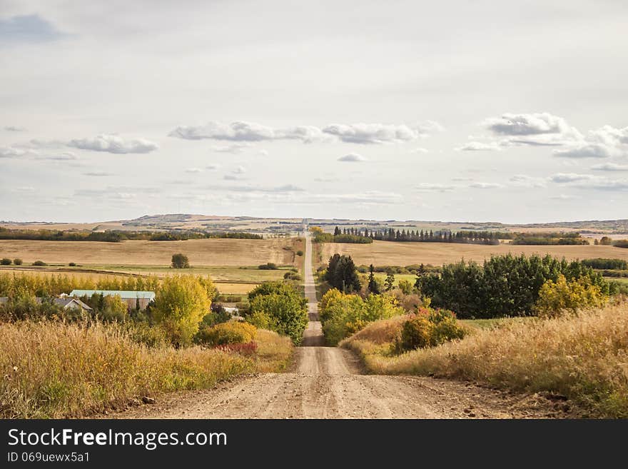 A gravel road through hilly countryside