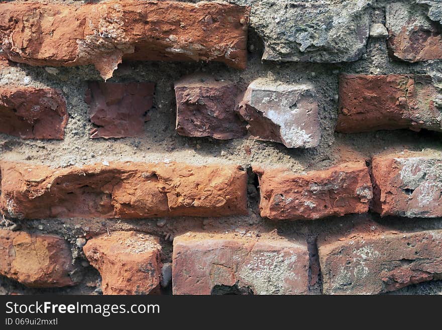 Closeup fragment of old ruined brick wall