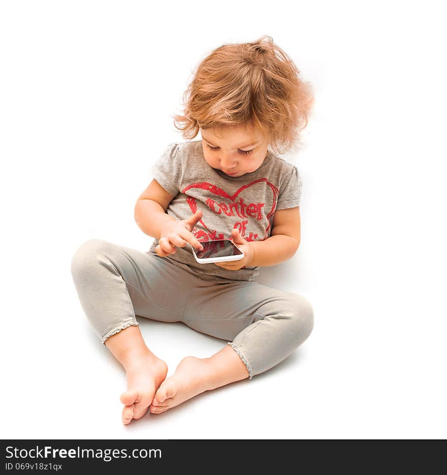 Little girl playing with white smartphone