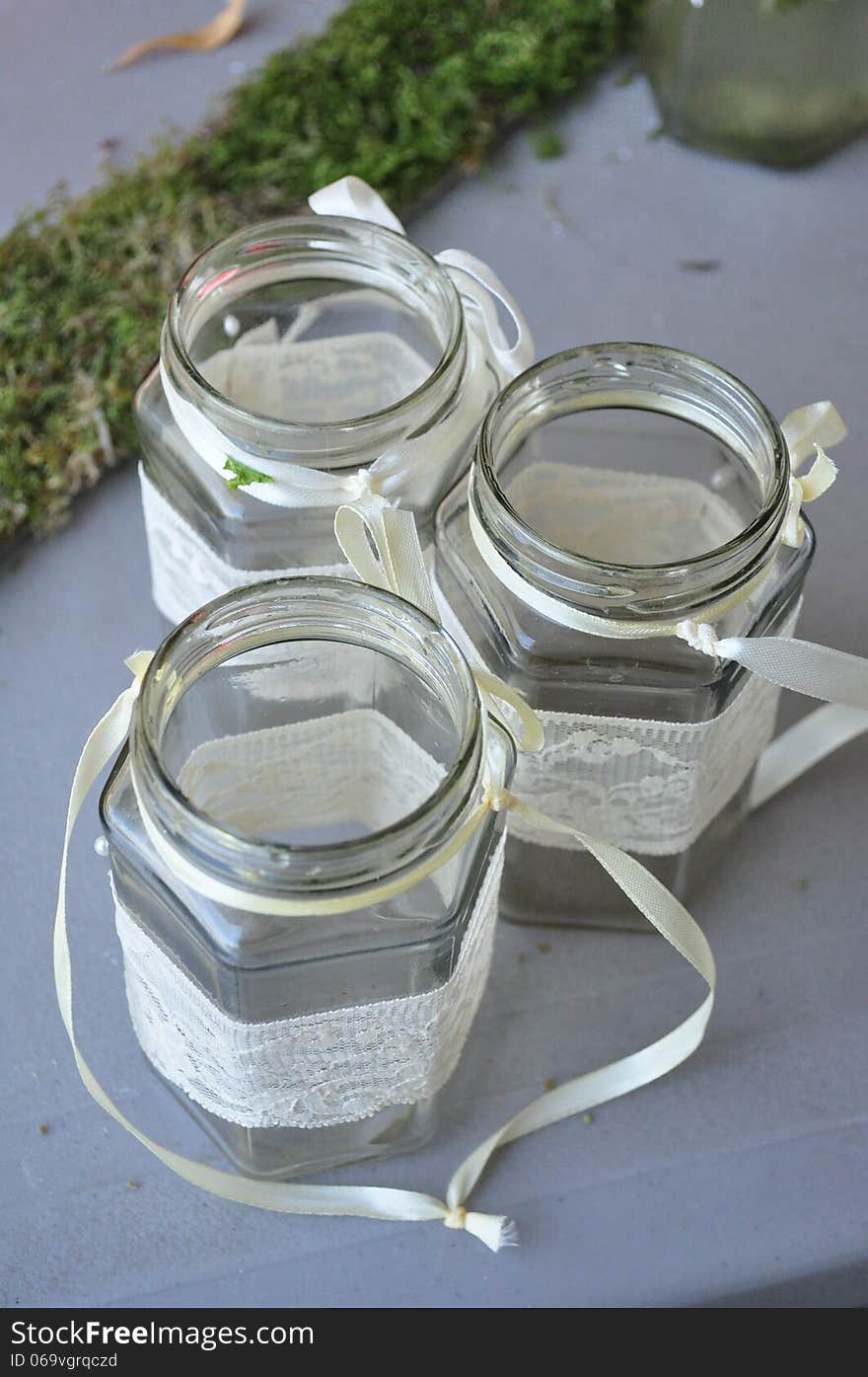 Empty jars decorated with lace. Empty jars decorated with lace.