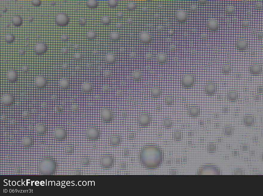 Water droplets refract light from computer screen and reflact ambient light producing interesting patterns. Water droplets refract light from computer screen and reflact ambient light producing interesting patterns.