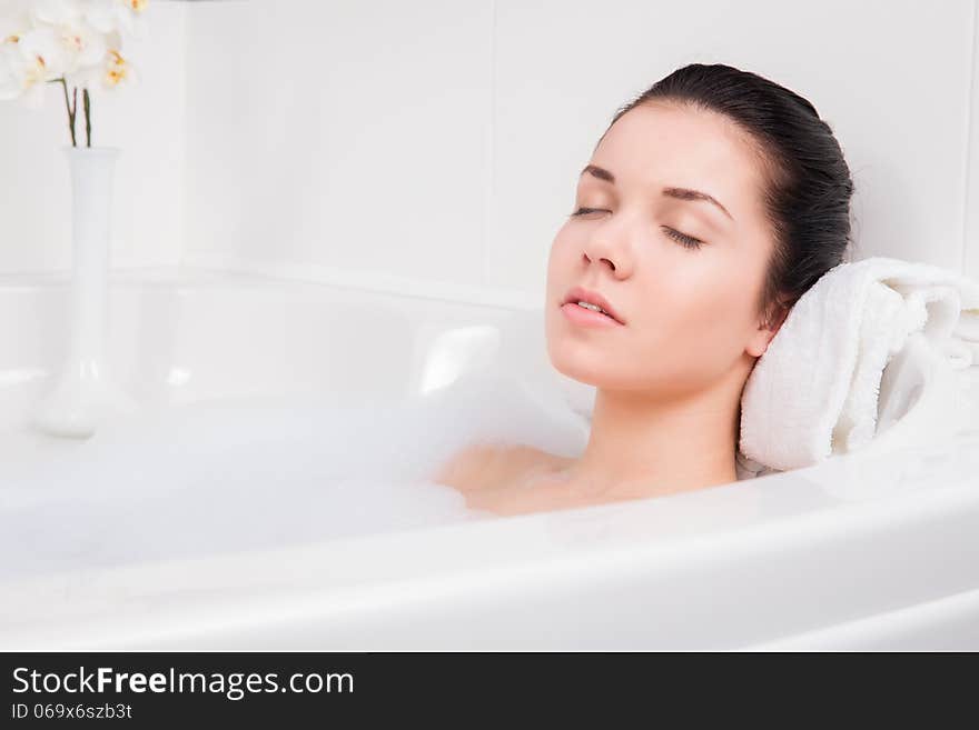 Beautiful woman takes bubble bath