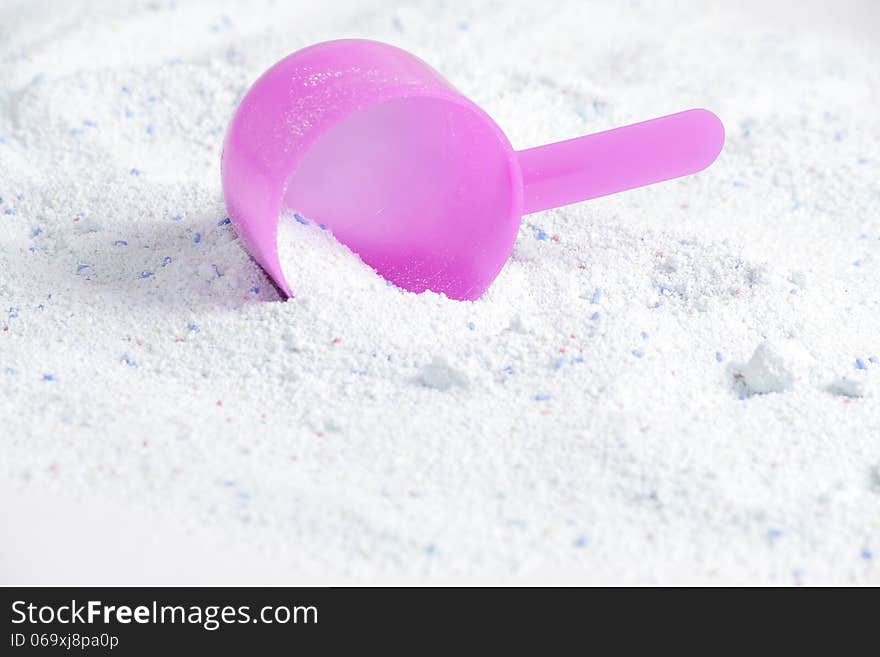 Washing powder with a measuring spoon