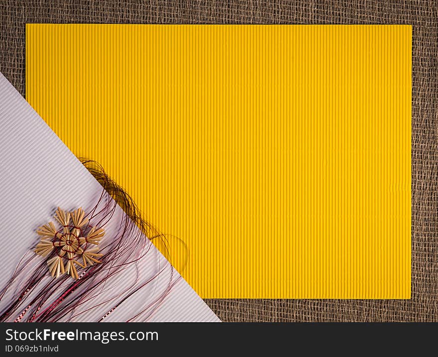 Background for Christmas greeting card. Composition of christmas straw decoration- snow flakes and angel, on red and yellow color textured paper background. Background for Christmas greeting card. Composition of christmas straw decoration- snow flakes and angel, on red and yellow color textured paper background.