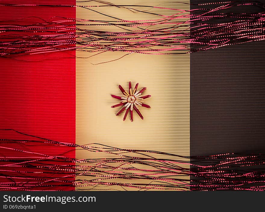 Background for Christmas greeting card. Composition of christmas straw decoration- snow flakes and angel, on red and yellow color textured paper background. Background for Christmas greeting card. Composition of christmas straw decoration- snow flakes and angel, on red and yellow color textured paper background.