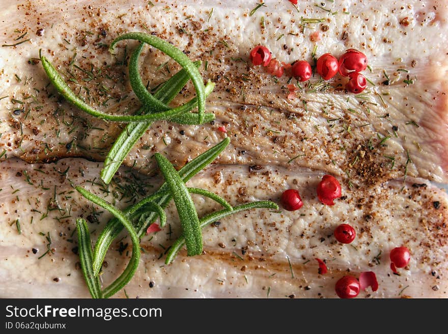 Spiced cooked meat with rosemary herb and rose pepper closeup. Spiced cooked meat with rosemary herb and rose pepper closeup