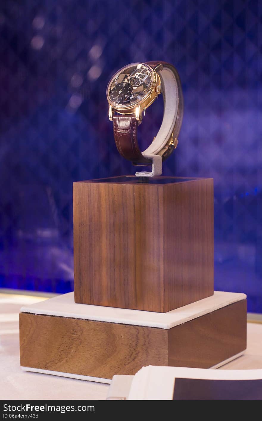 Luxury man watch on wood stand in shop with blue background