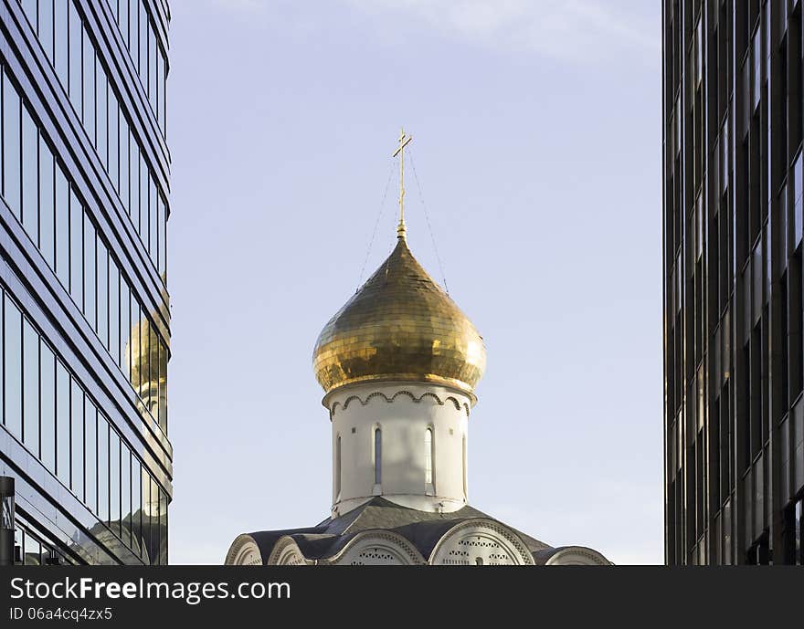 Orthodoxy church between skyscrapers in Moscow near metro Belorusskaya