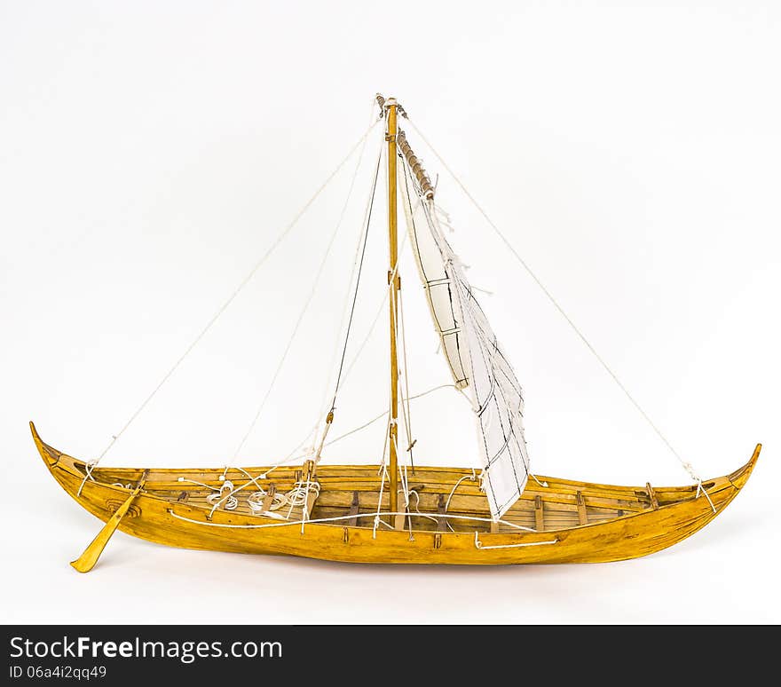 Wooden model Viking ship . White background. Side view. Wooden model Viking ship . White background. Side view