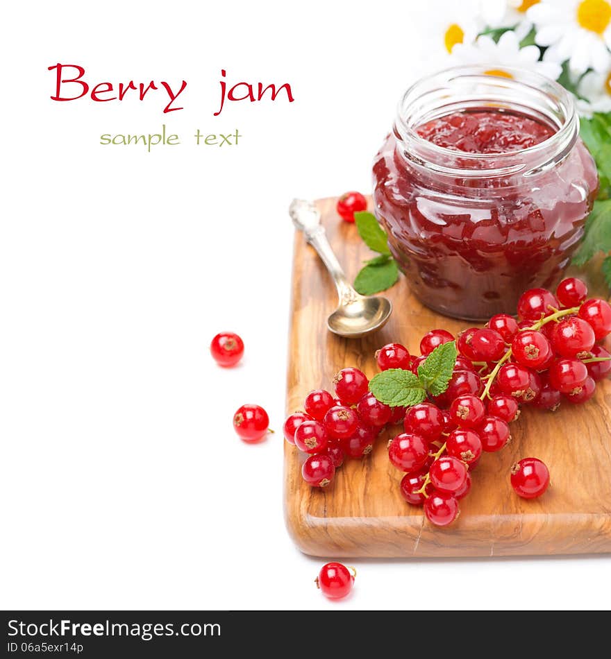 Berry jam in a glass jar and fresh red currants on a wooden board, isolated on white. Berry jam in a glass jar and fresh red currants on a wooden board, isolated on white