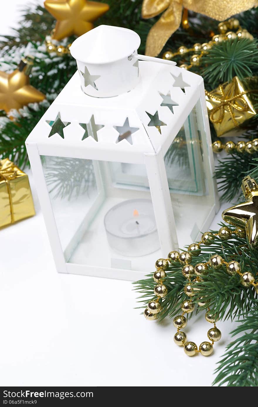 Christmas composition with a white lantern, fir branches and decorations, close-up. Christmas composition with a white lantern, fir branches and decorations, close-up