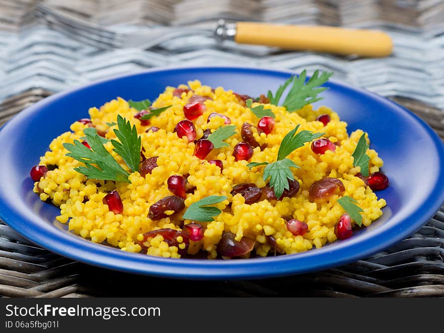 Couscous salad with curry, cranberries and herbs