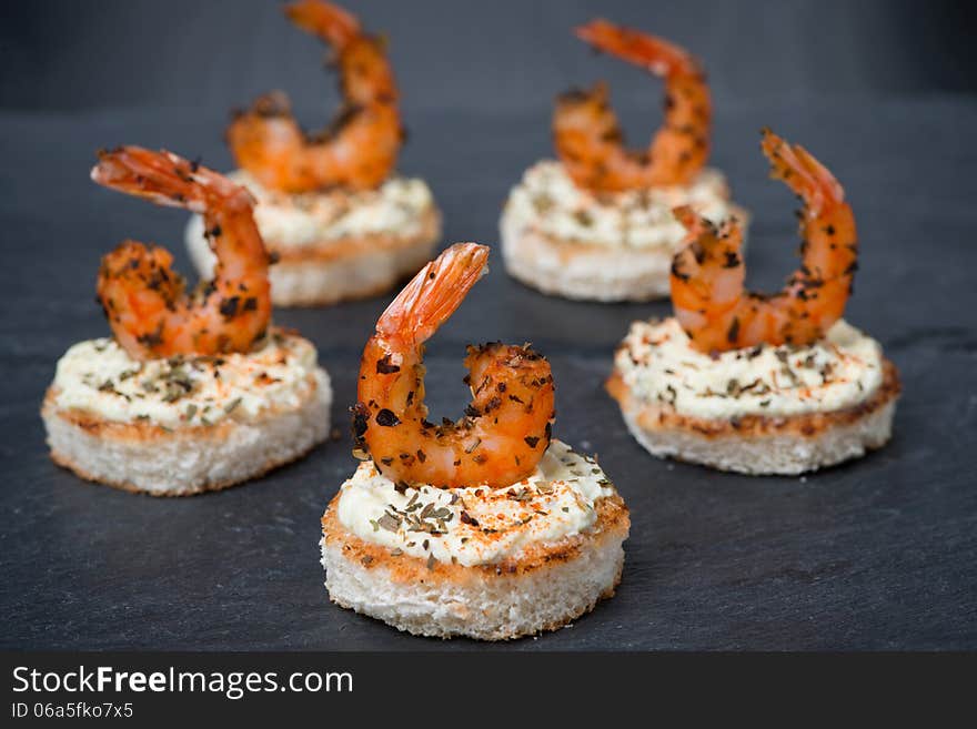 Festive appetizer with spicy shrimps on toast