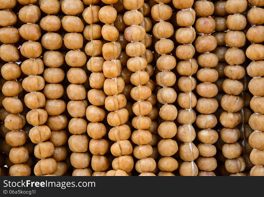 Small sausages hanging on to the rail.