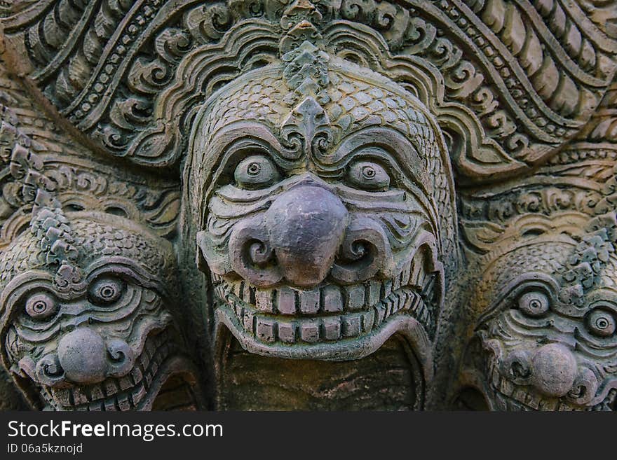 Stone statue on the wall of the temple in Thailand.