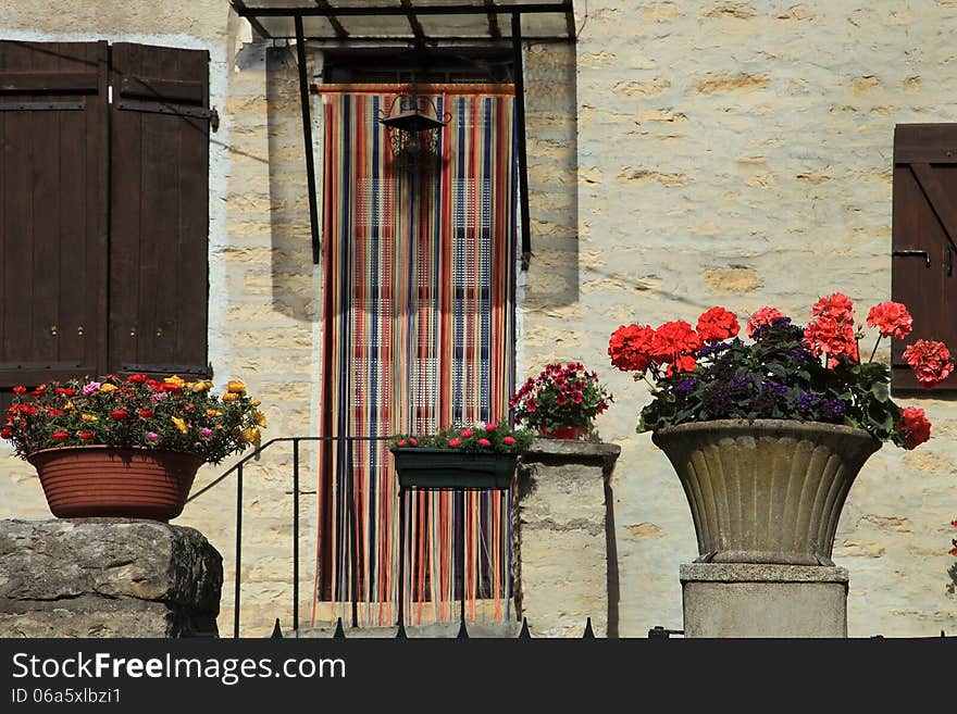 The wall of the house decorated with flowers, France