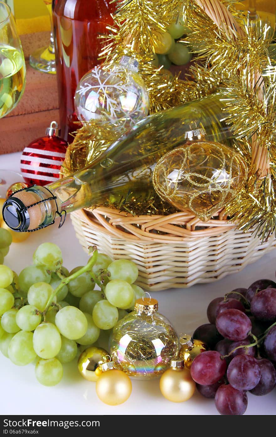 Bottle of white wine with grapes and Christmas decorations on white background. Bottle of white wine with grapes and Christmas decorations on white background