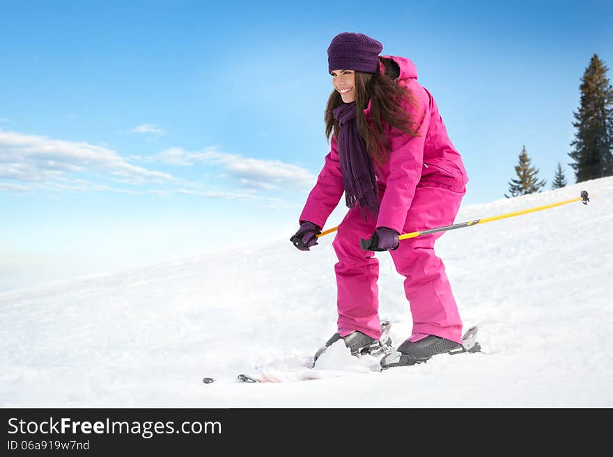 Young woman skiing fast on the slope. Winter vacation