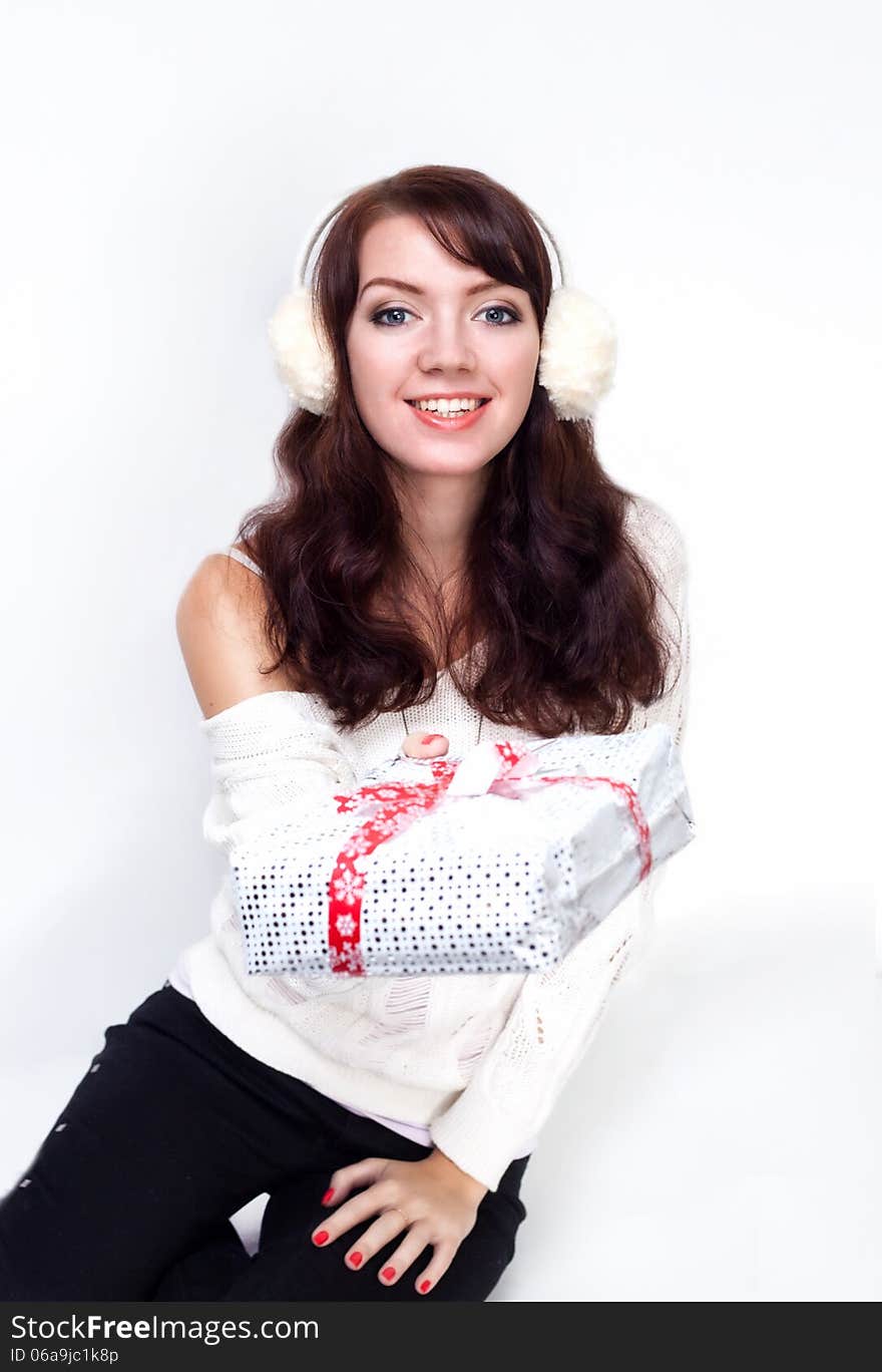 Smiling girl giving you a present on white background