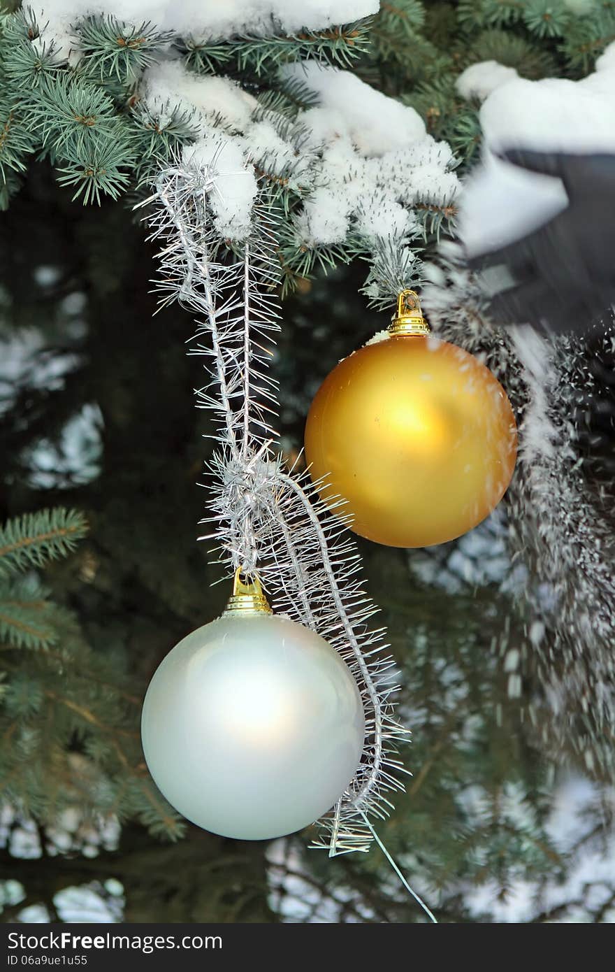 Christmas balls on fir-tree in snow