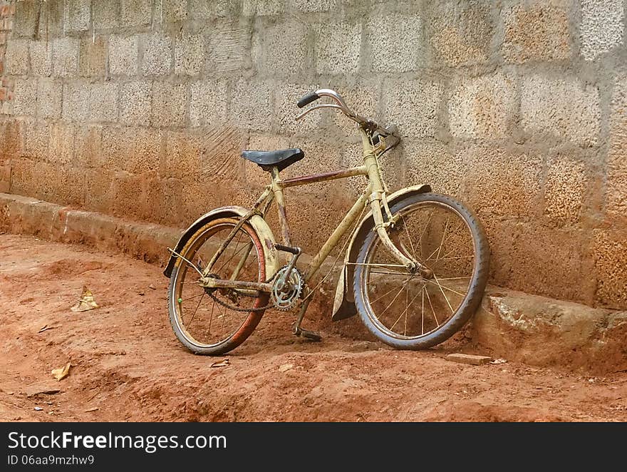 Bike against a brick wall in rural India. Bike against a brick wall in rural India