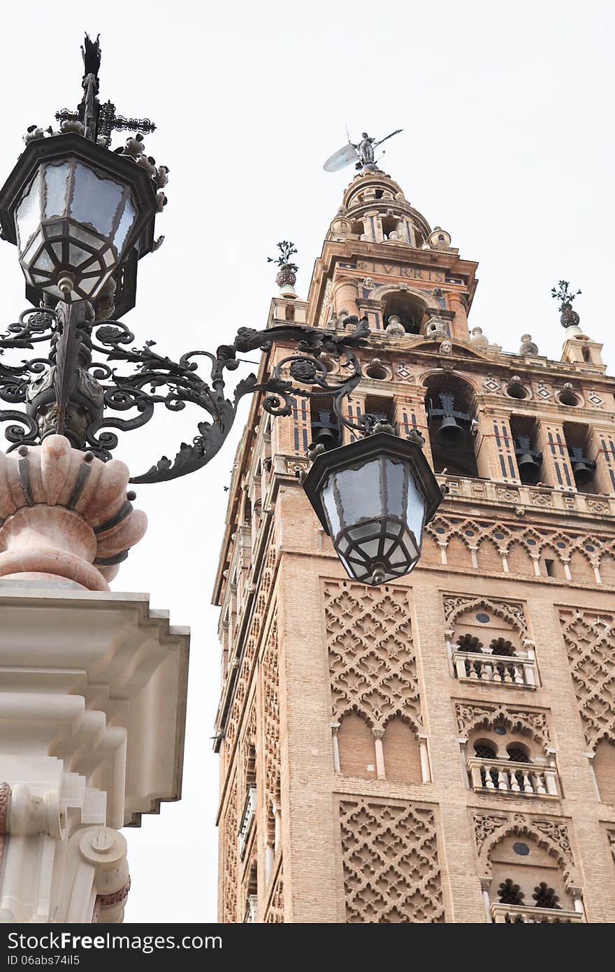 Nice old street lamp against belfry of Seville Cathedral, Spain. Nice old street lamp against belfry of Seville Cathedral, Spain