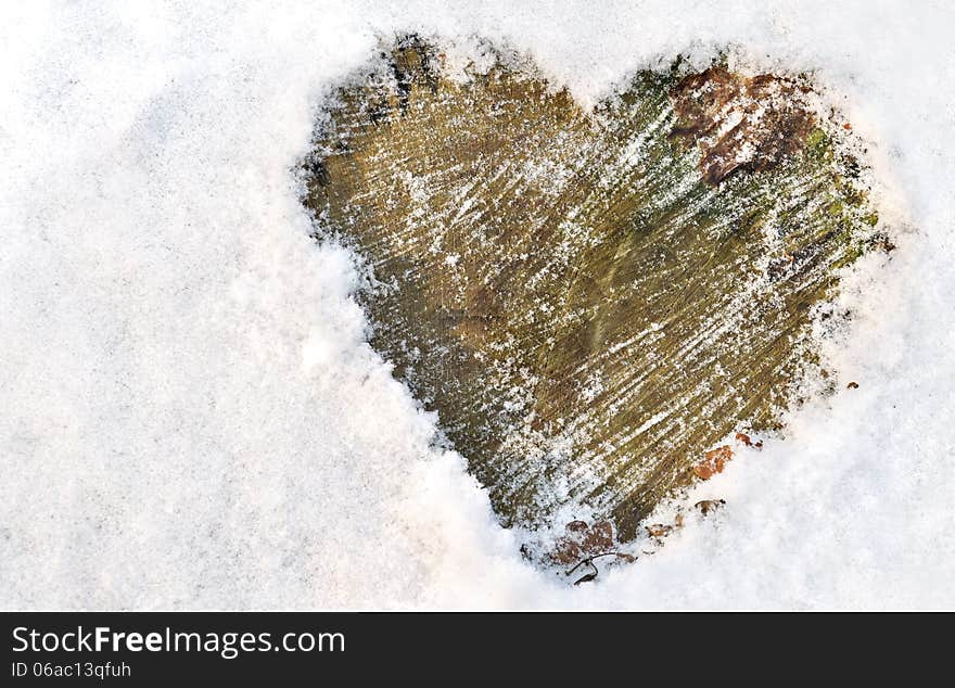 Heart drawn in the snow on wood. Heart drawn in the snow on wood