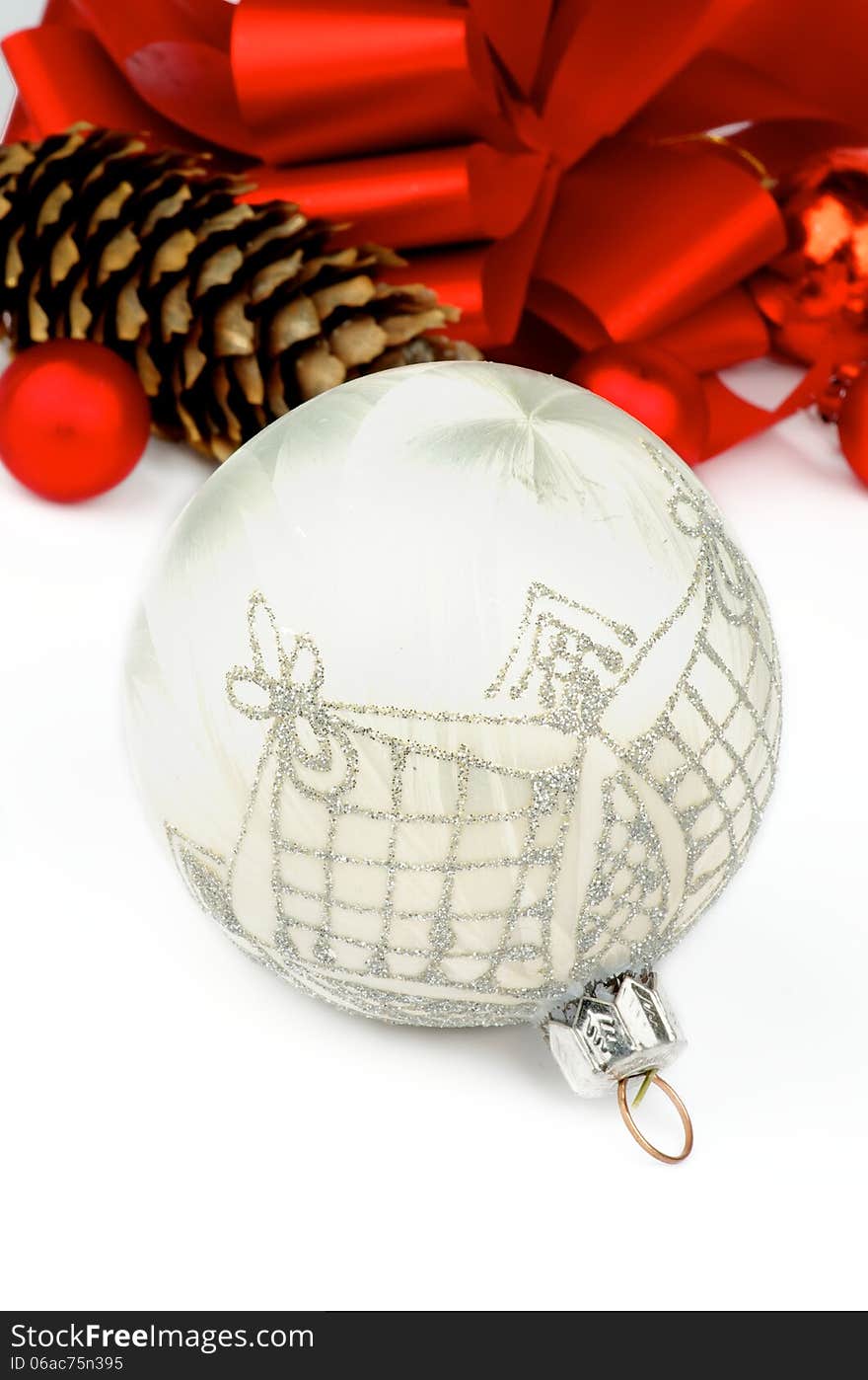 Handmade White Silk Christmas Ball with Silver Decoration on Holiday Ribbons and Baubles background closeup