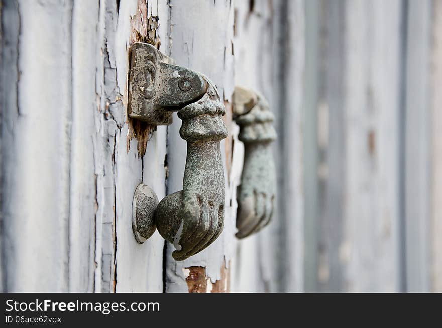 Old iron ring knocker in hand shape