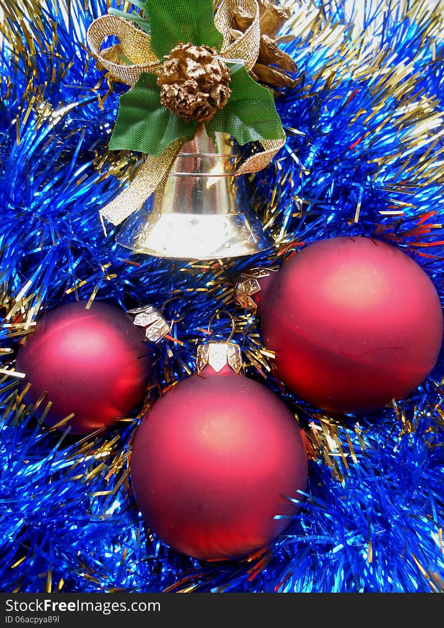 Christmas and New Year decorations red balls on a background of blue tinsel