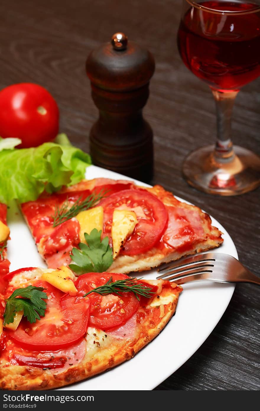 Still life with freshness pizza on plate near vegetables and wine