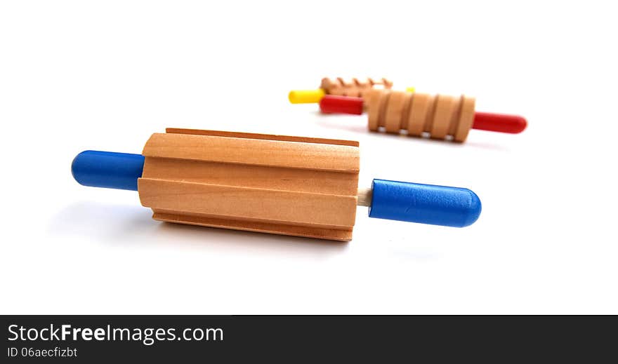 Colorful rolling pin toys, all made out of wood with a different pattern for each. Colorful rolling pin toys, all made out of wood with a different pattern for each