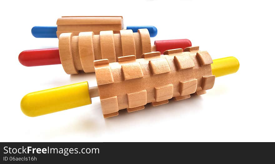 Colorful rolling pin toys, all made out of wood with a different pattern for each. Colorful rolling pin toys, all made out of wood with a different pattern for each