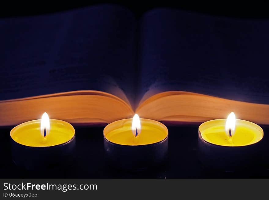 Three candles with open bible. Three candles with open bible