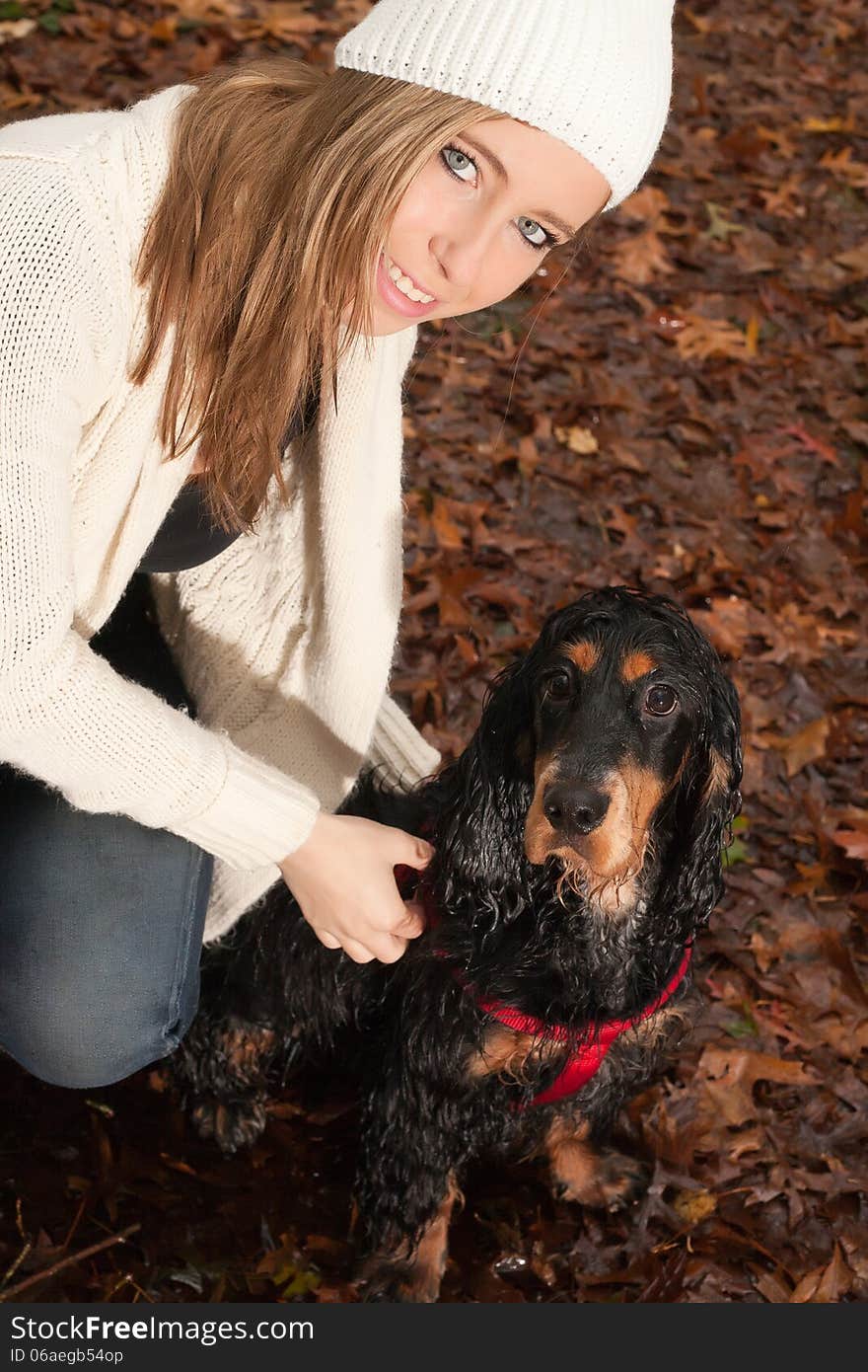 Girl and her dog are having a wet time in the rain. Girl and her dog are having a wet time in the rain