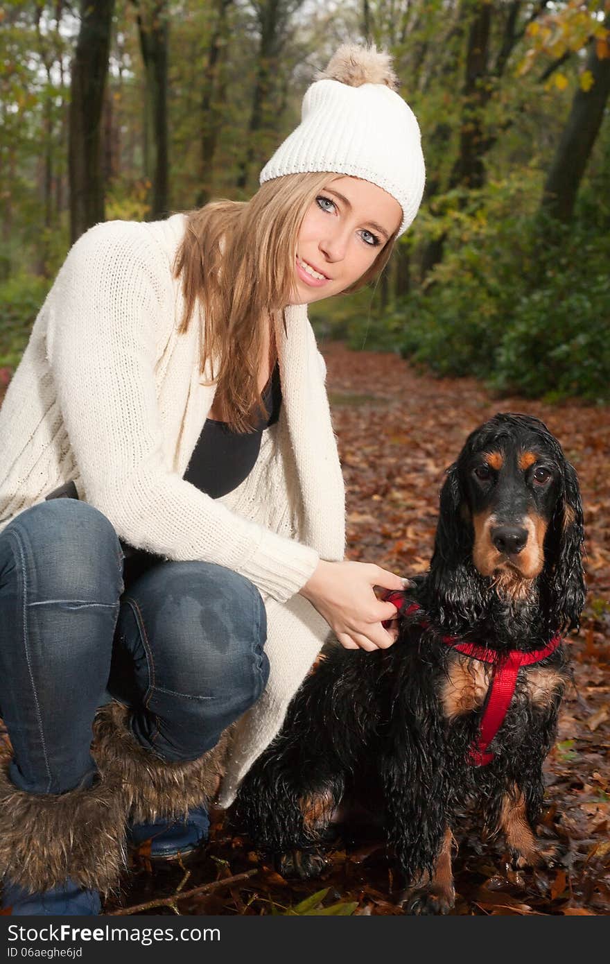 Girl and her dog are having a wet time in the rain. Girl and her dog are having a wet time in the rain