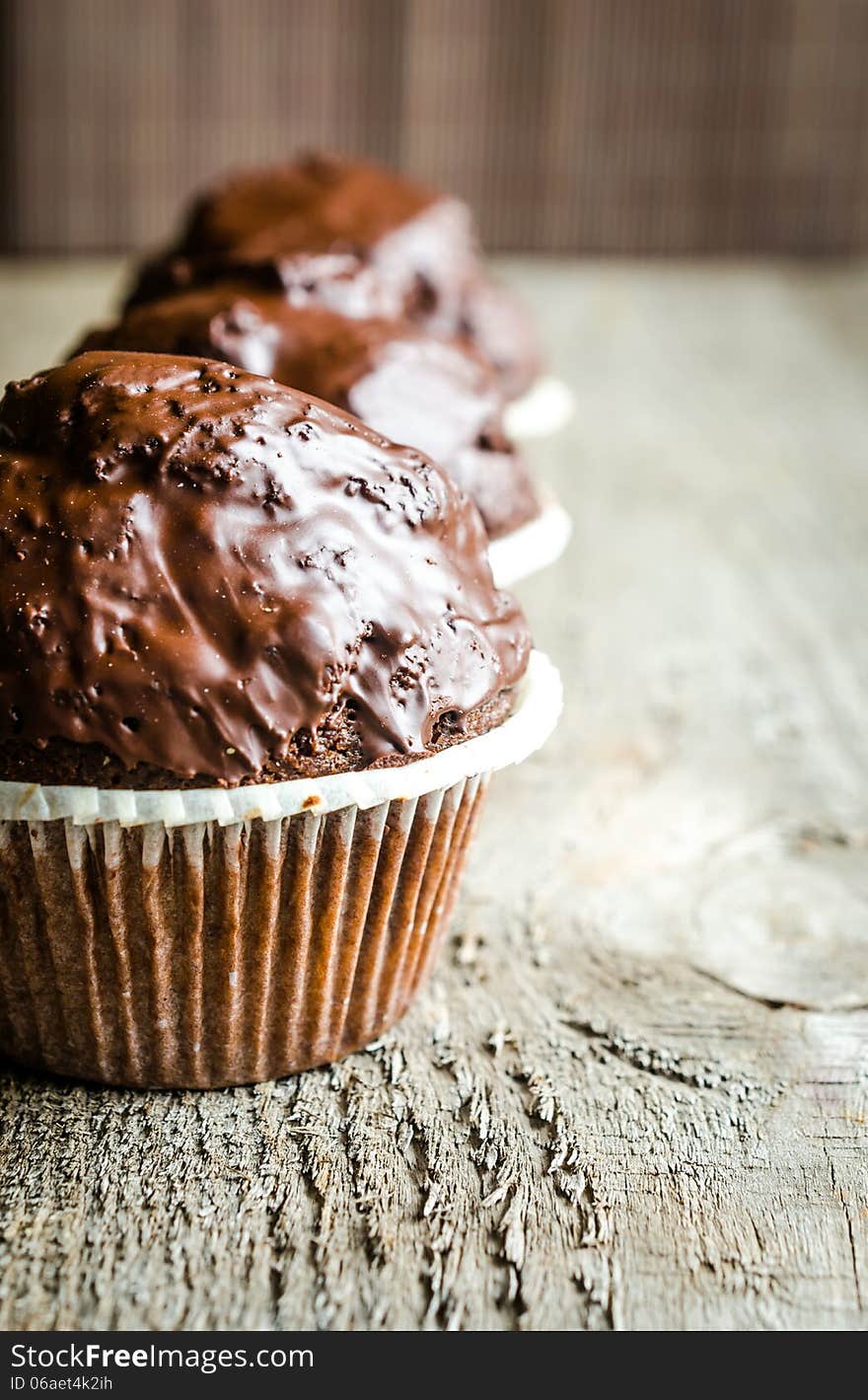 Row of three chocolate muffins