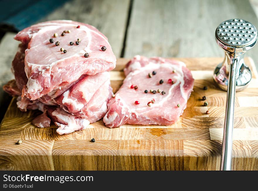 Raw pork steaks on the cutting board