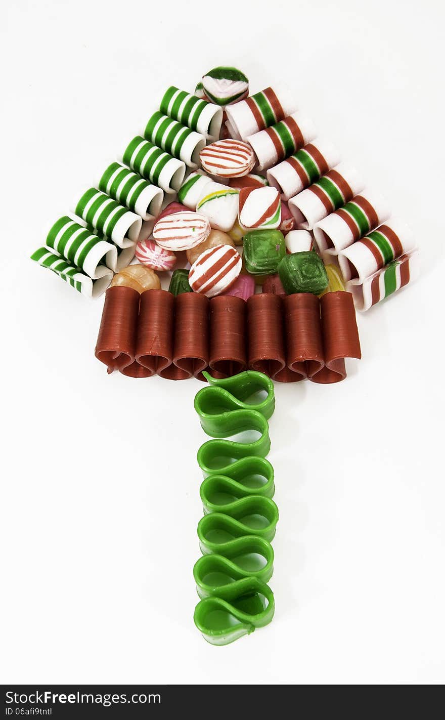 Christmas tree formed with Christmas ribbon and hard candies against a white background. Christmas tree formed with Christmas ribbon and hard candies against a white background